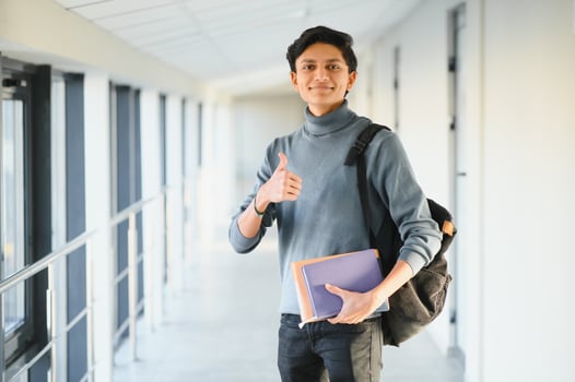 Portrait of indian college boy holding books. photo