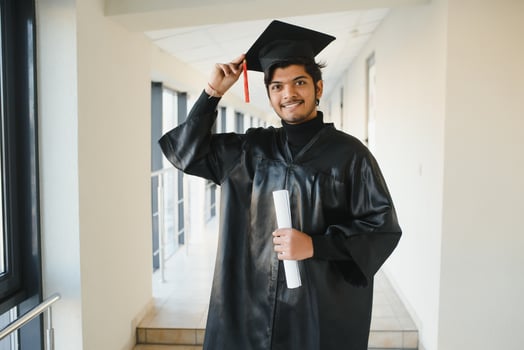 portrait of successful indian student in graduation gown. photo