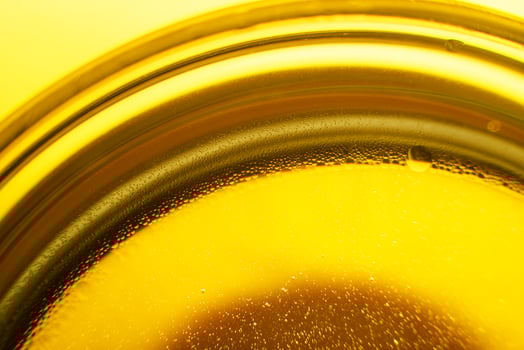 Yellow oil bubbles on water, cooking oil background. photo