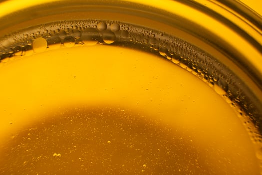 Yellow oil bubbles on water, cooking oil background. photo
