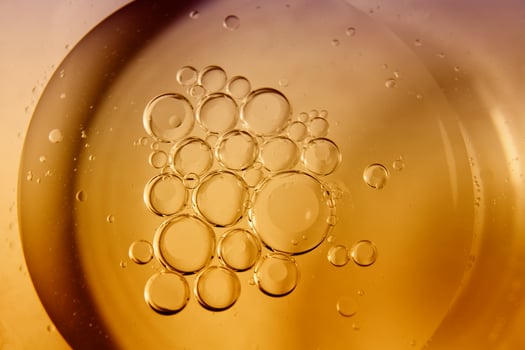 Yellow bubbles and drops of oil background, kitchen pattern, orange beverage background. photo