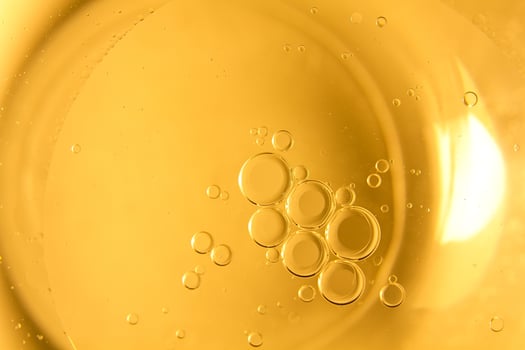 Yellow bubbles and drops of oil background, kitchen pattern, orange beverage background. photo