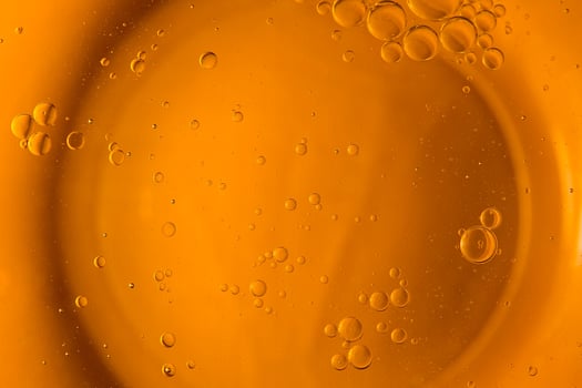 Yellow bubbles and drops of oil background, kitchen pattern, orange beverage background. photo