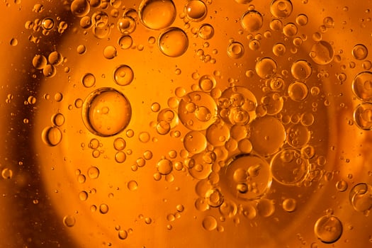 Yellow bubbles and drops of oil background, kitchen pattern, orange beverage background. photo
