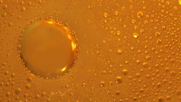 Cooking oil, water with oil emulsions and bubbles in the background. photo