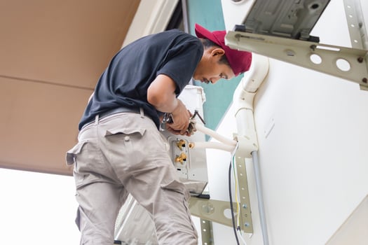 Technician install new air conditioning, Repairman service for repair and maintenance of air conditioners photo