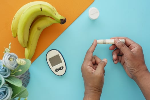 man's hand measuring blood sugar level photo