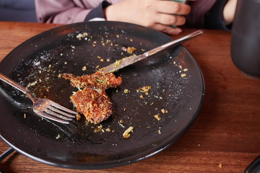 An empty dirty plate with a fork. photo