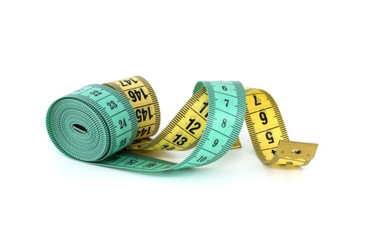 Green and yellow measuring tape isolated on white background photo