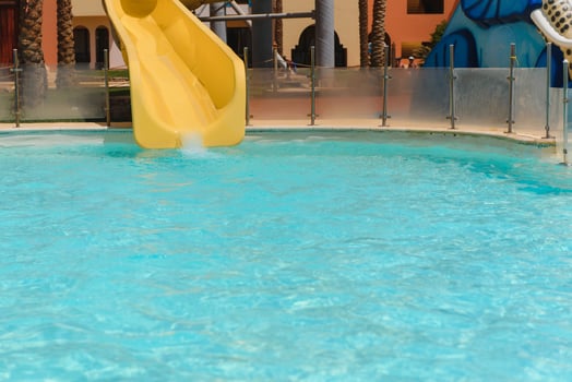 Colorful aquapark constructions in swimming-pool photo
