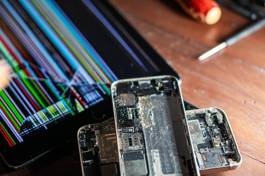 Broken smartphone and tablet with damaged screens photo