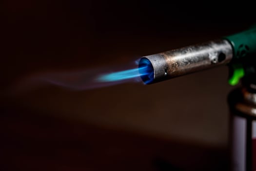 Lit blowtorch with blue flame photo
