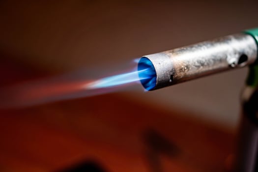 Lit blowtorch with blue flame photo