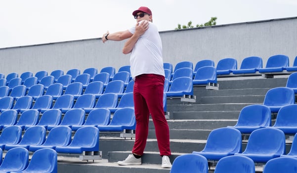 sportsman running in the stadium among blue seats photo