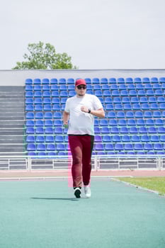 sportsman running in the stadium photo