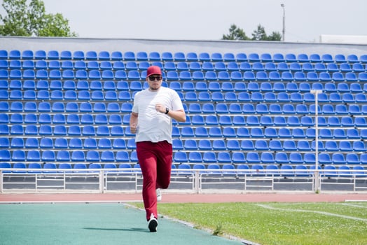 sportsman running in the stadium photo