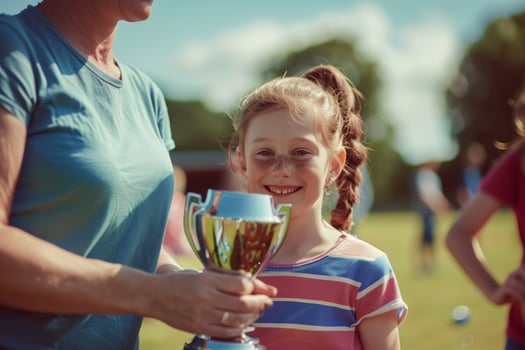 Young Girl Holding Sports Trophy photo