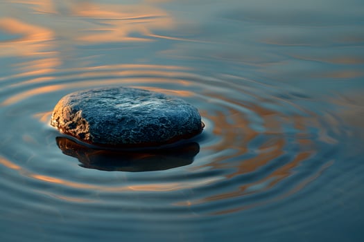 Rock in water with frosty surface photo