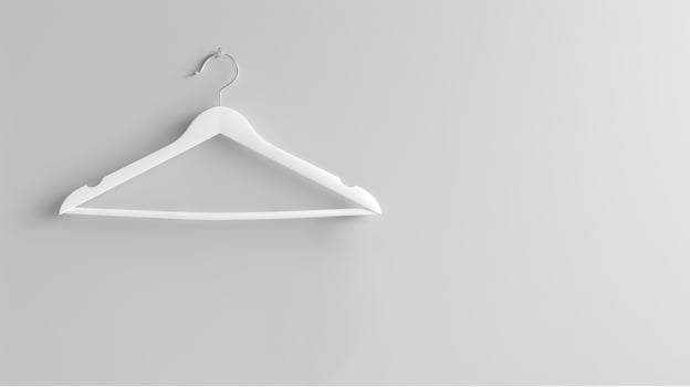 White Clothes Hanger on Plain White Wall. Concept of Organization, Minimalism, Simplicity, Interior Design. Copy space photo