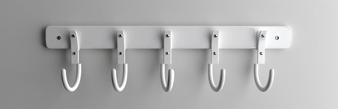 White modern coat rack with five hooks mounted on a wall. Minimalist home organization concept. Concept of interior design, home storage, simplicity, functionality photo