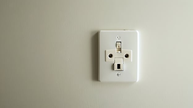 UK three-pin electrical outlet on a gray wall. UK power socket. Concept of home improvement, electricity, interior design, infrastructure photo