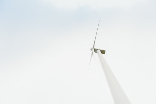 Windmill against cloudy sky with copyspace photo