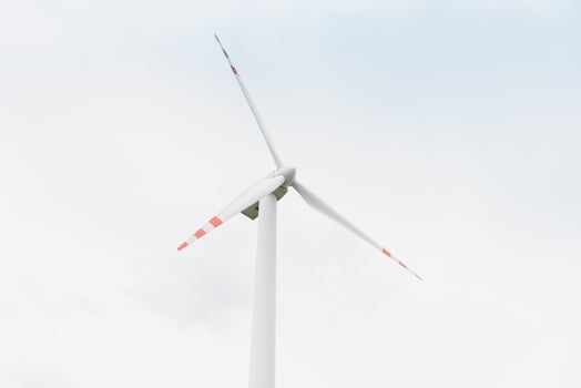 Windmill against cloudy sky with copyspace photo