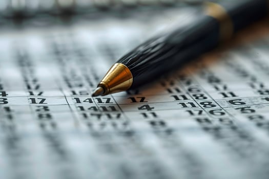 A close up of a pen on a calendar with numbers photo