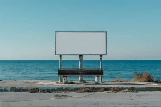 An empty bench on the side of the road by the water photo