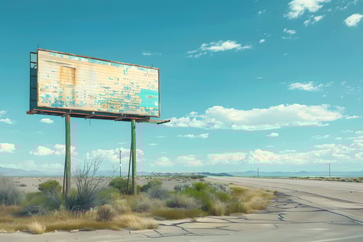 A billboard on the side of the road with a sky background photo