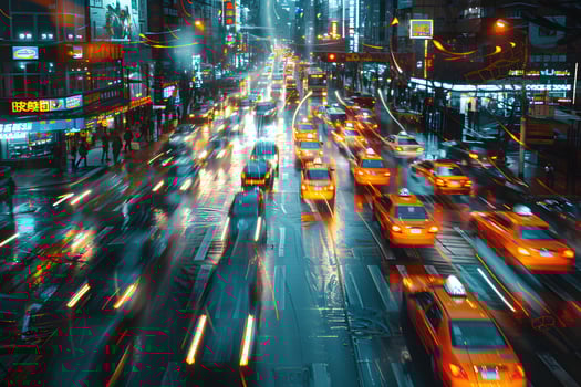 Cars and buses driving on busy city street at night photo