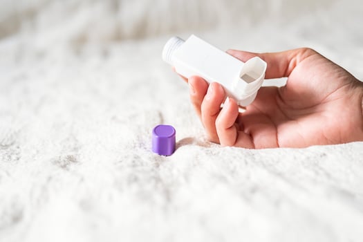 Woman holding asthma inhaler applying for prevent asthma attack. photo