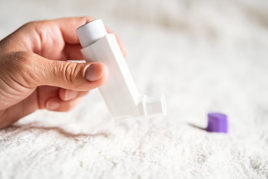 Females hand holding inhaler for asthmatics. photo