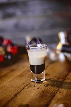 Glass of Liquid on Wooden Table photo