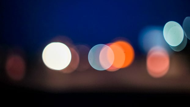Blurred lights evening city traffic bokeh. Defocused night city traffic. Blurred lights bokeh car headlights driving evening city road. City night traffic background photo