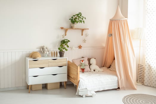 a cozy and bright children's room with a four-poster bed, a chest of drawers, a floor lamp and cute soft toys. light background photo