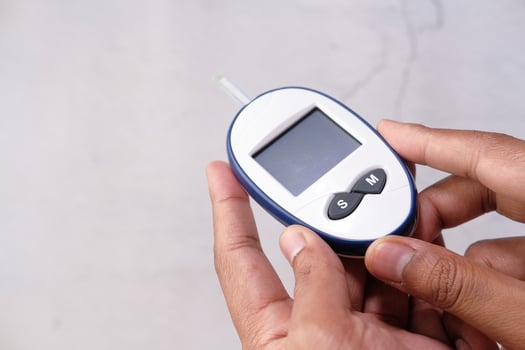 hand holding diabetic measurement kit isolated on white photo