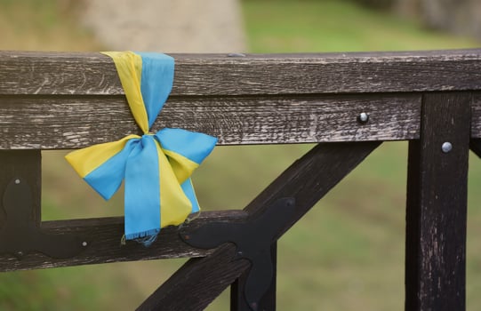 Ribbons in the colors of the national flag of Ukraine are tied to the handrail photo