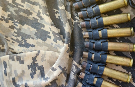 Ukrainian army fabric and machine gun belt shells lies on ukrainian pixeled military camouflage photo