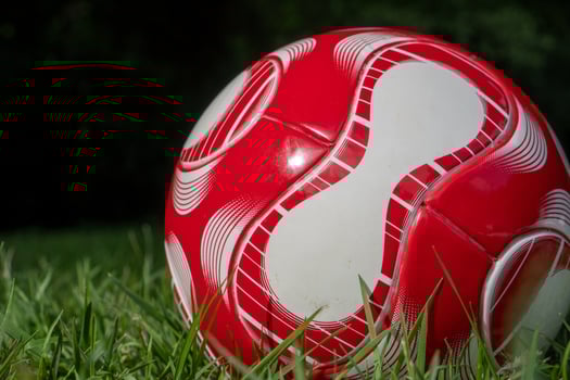 red soccer ball on the field photo