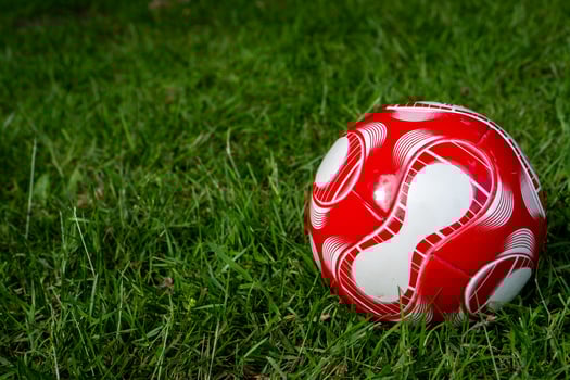 red soccer ball on the field photo