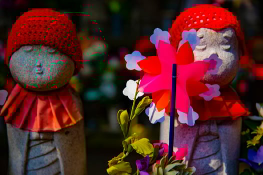 Statue guardian wearing red hat in Tokyo daytime photo