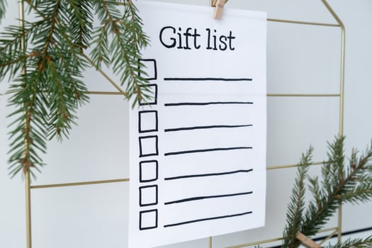Preparation for winter holidays. GIFT LIST text on paper note. Celebration gifts and presents preparing Natural zero waste homemade Christmas decor. Happy new year concept. photo