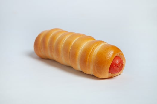 Sausage in the dough isolated on a white background. photo
