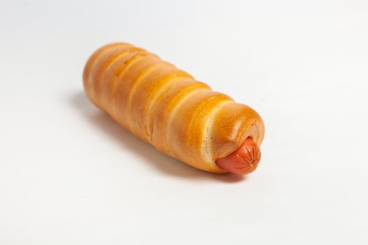 Sausage in the dough isolated on a white background. photo