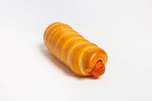 Sausage in the dough isolated on a white background. photo