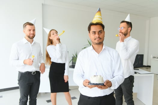 Surprise. Mixed race happy people celebrating a birthday of colleague in the modern office photo