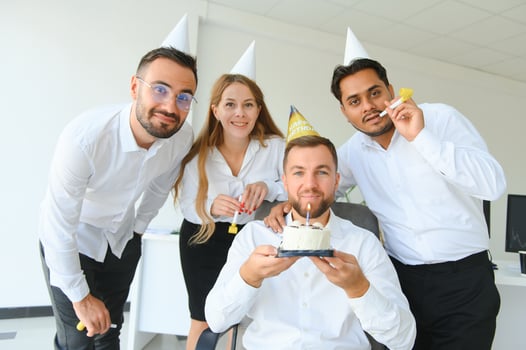 Business team celebrating a birthday of collegue in the modern office. photo