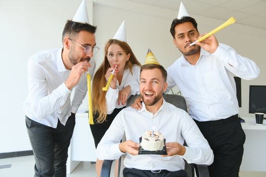 Business team celebrating a birthday of collegue in the modern office. photo