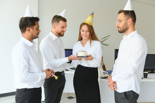 Business team celebrating a birthday of collegue in the modern office. photo